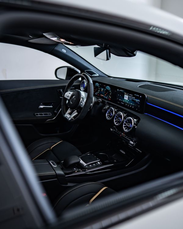 A cleaned and conditioned car interior with the door open
